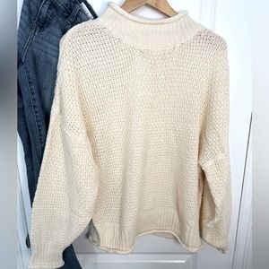 Large cream colored, mock turtle neck.